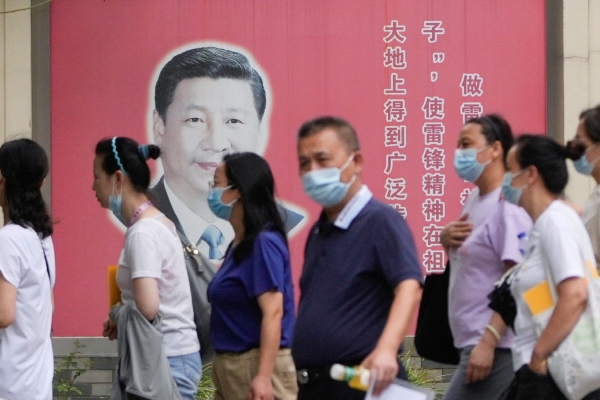 ▲중국 상하이에서 지난달 31일 마스크를 쓴 시민들 뒤로 시진핑 국가주석의 얼굴이 보인다. 상하이/로이터연합뉴스
