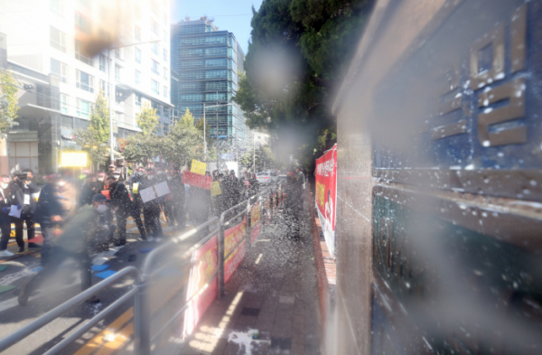 ▲푸르밀에 원유를 공급하는 축산 농민들이 서울 푸르밀 본사 앞에서 규탄집회를 열고 푸르밀 우유를 건물을 향해 던지고 있다.  (뉴시스)