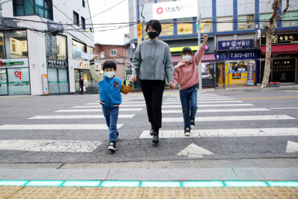 ▲LED 바닥형 보행신호등을 건너고 있는 아이들. (자료제공=관악구)