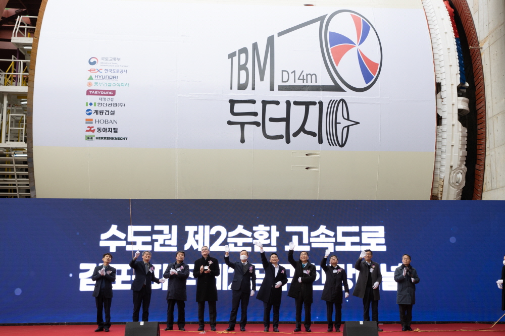 ▲13일 수도권 제2순환 고속도로 김포~파주 간 건설현장이 경기도 파주시 송촌동에서 열린 TBM(Tunnel Boring Machine) 굴진 기념식에서 참석자들이 기념촬영을 하고 있다. (사진제공=국토교통부)