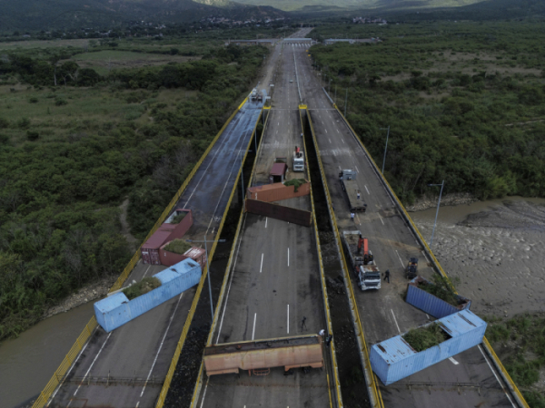 ▲지난해 12월 15일(현지시간) 인부들이 콜롬비아와 쿠쿠타에서 티엔디타스를 가로 막고 있던 컨테이너 해체작업을 하고 있다. 쿠쿠타/AP뉴시스