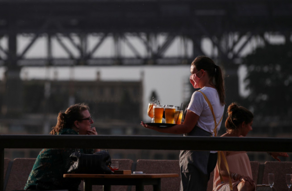 ▲2021년 1월 14일 호주 시드니 야외 펍에서 점원이 맥주를 전달하고 있다. 시드니(호주)/신화뉴시스  
