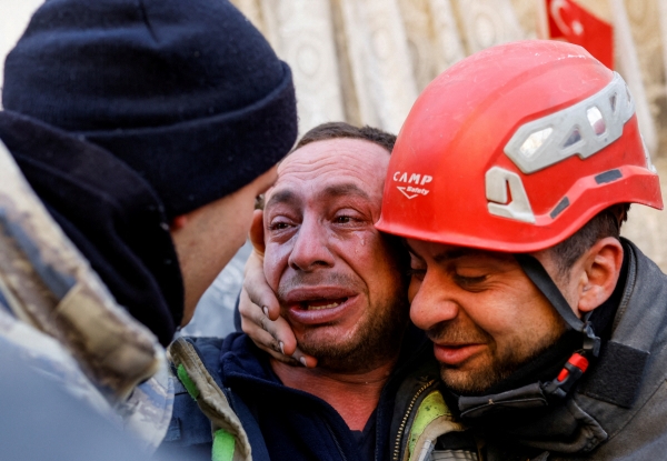 ▲튀르키예 하타이에서 11일(현지시간) 생존자와 구조대원이 부둥켜 안고 있다. (하타이(튀르키예)/로이터연합뉴스)