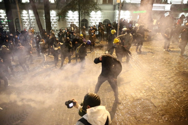 ▲조지아 트빌리시에서 8일(현지시간) 시위대가 물대포와 최루가스를 피해 몸을 숨기고 있다. 트빌리시/AFP연합뉴스
