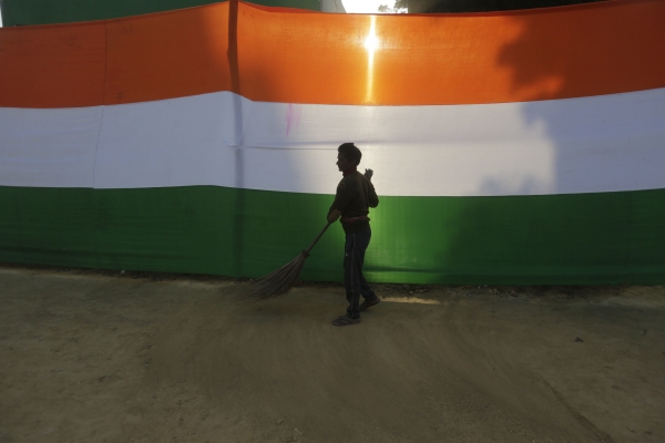 ▲인도 알라하바드에서 한 노동자가 인도 국기 앞에서 청소를 하고 있다. 알라하바드(인도)/AP뉴시스 
