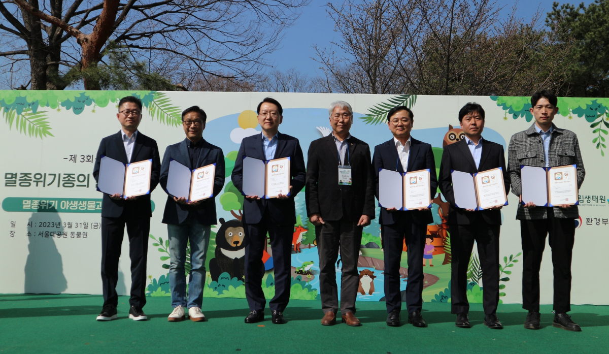 ▲3월 31일, 서울대공원에서 진행된 ‘멸종위기종의 날’ 행사에서 ‘멸종위기 야생생물 보전 후원 인정제’에 선정된 기업의 관계자가 인증서를 수상하고 기념촬영을 하고 있다. 사진은 왼쪽부터 윤인수 한섬 상무, 우병재 SK가스 부사장, 이주한 효성첨단소재 상무, 조도순 국립생태원 원장, 최형식 효성화학 상무, 임성원 LG헬로비전 상무, 한국가스공사 관계자 (사진제공=SK가스)