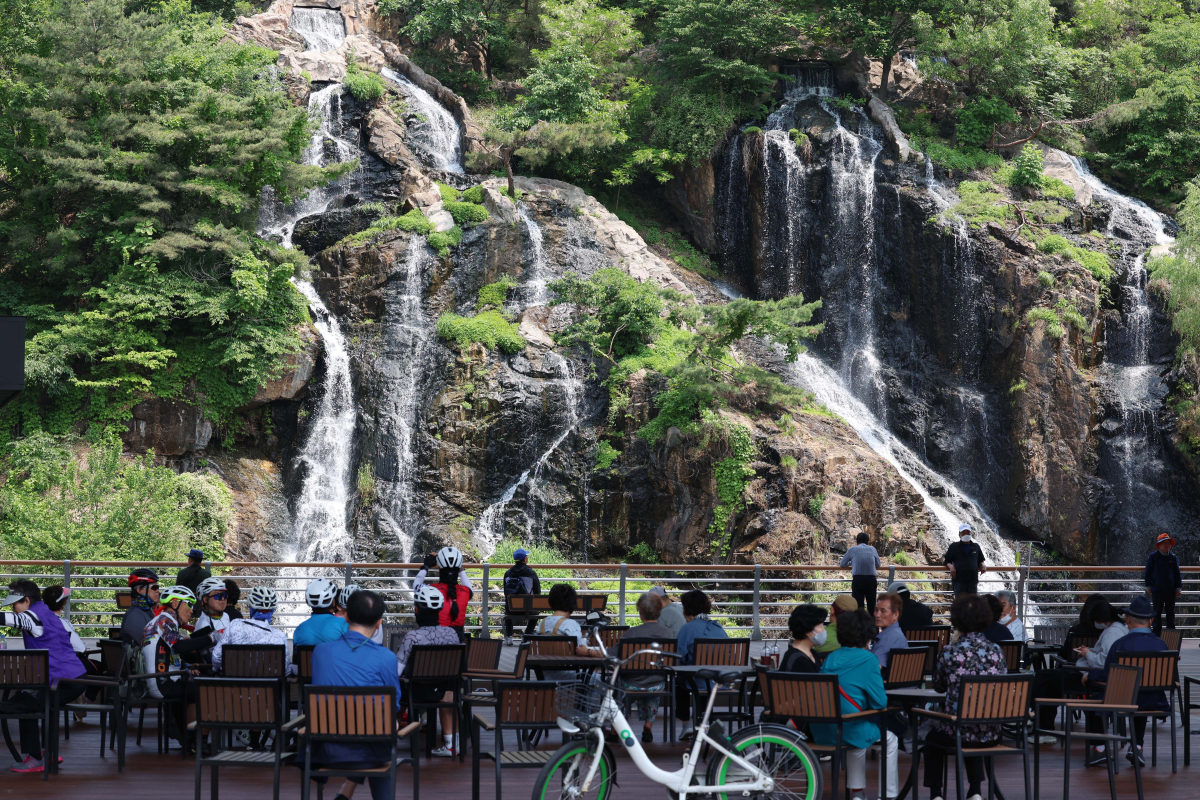 ▲전국이 평년기온을 웃도는 초여름날씨를 보인 15일 서울 서대문구 홍제천 인공폭포 앞 그늘에서 시민들이 더위를 식히고 있다. 신태현 기자 holjjak@