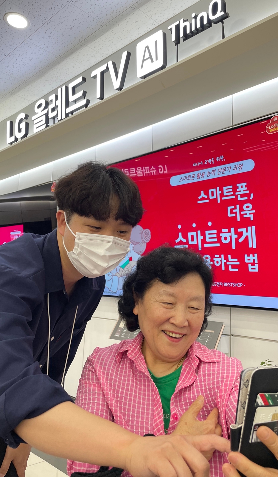 ▲지난 22일 경기도 용인시 수지구 LG베스트샵 수지점에서 지점장과 모바일 매니저가 어르신들에게 스마트폰 활용법을 교육하고 있다. (사진제공=LG전자)