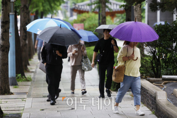 ▲낮의 길이가 가장 길다는 절기상 하지인 21일 오전 서울 종로구 광화문역 일대에서 우산을 쓴 시민들이 출근길 발걸음을 재촉하고 있다. 기상청은 전국에 내리는 비가 제주도를 시작으로 오후에는 대부분 그치겠다고 예보했다. 조현호 기자 hyunho@