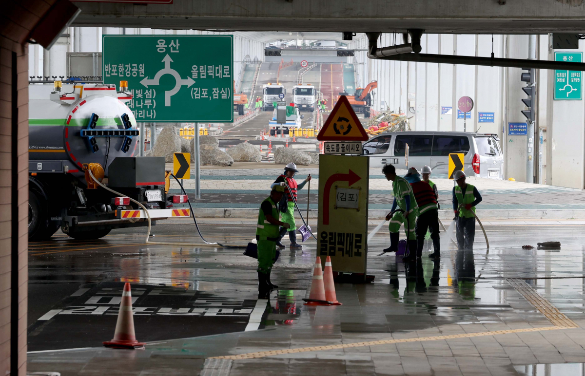 ▲17일 서울 잠수교 양방향 통행이 장맛비와 팔당댐 방류 등으로 나흘째 통제된 가운데 관계자들이 통행재개를 위해 청소를 하고 있다. 신태현 기자 holjjak@