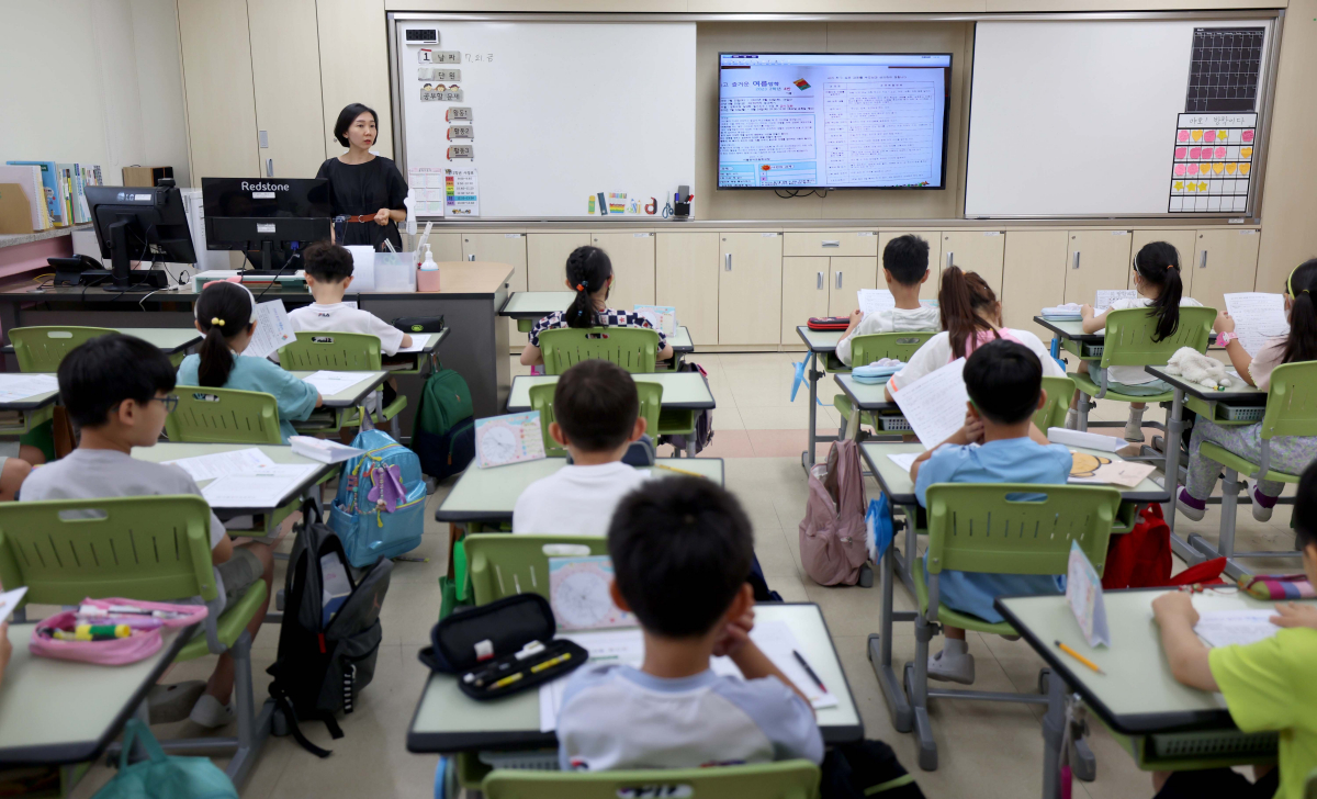 ▲21일 서울 마포구 공덕초에서 여름방학을 맞이한 학생들이 담임선생님의 설명을 듣고 있다. 신태현 기자 holjjak@