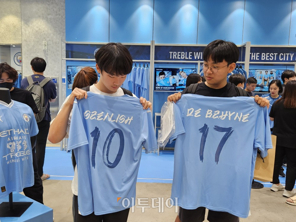 ▲28일 서울 잠실 롯데월드몰 3층 푸마 매장에서 한정판 유니폼을 구매한 고객들이 유니폼을 들고 있다. (문현호 기자 m2h@)