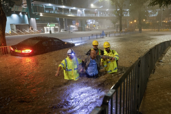 ▲홍콩에 139년 만의 기록적인 폭우가 쏟아진 가운데 8일 침수된 도로에서 배수 직원들이 한 주민의 도피를 돕고 있다. 홍콩/로이터연합뉴스
