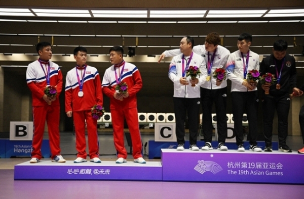 ▲10m 러닝타깃 단체전 시상식에서 2위 북한 선수들이 1위 한국 선수와의 사진 촬영을 거부했다. 출처=로이터
