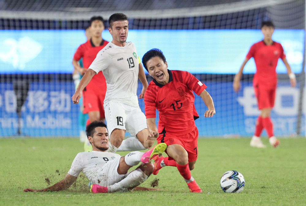 ▲4일 중국 항저우 황룽 스포츠센터 스타디움에서 열린 2022 항저우 아시안게임 남자축구 4강전 대한민국과 우즈베키스탄의 경기.    상대 수비가 대한민국 정호연을 상대로 거친 태클을 시도하고 있다.  (연합뉴스)