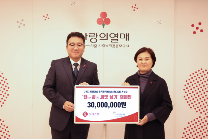 ▲구경영(왼쪽) 롯데건설 ESG 팀장과 신혜영 사랑의열매 사무처장이 전달식 이후 기념촬영을 하고 있다. (사진제공=롯데건설)