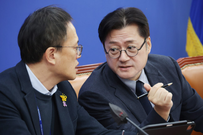 ▲더불어민주당 홍익표 원내대표(오른쪽)가 28일 국회에서 열린 원내대책회의에서 박주민 의원과 대화하고 있다.  (연합뉴스)