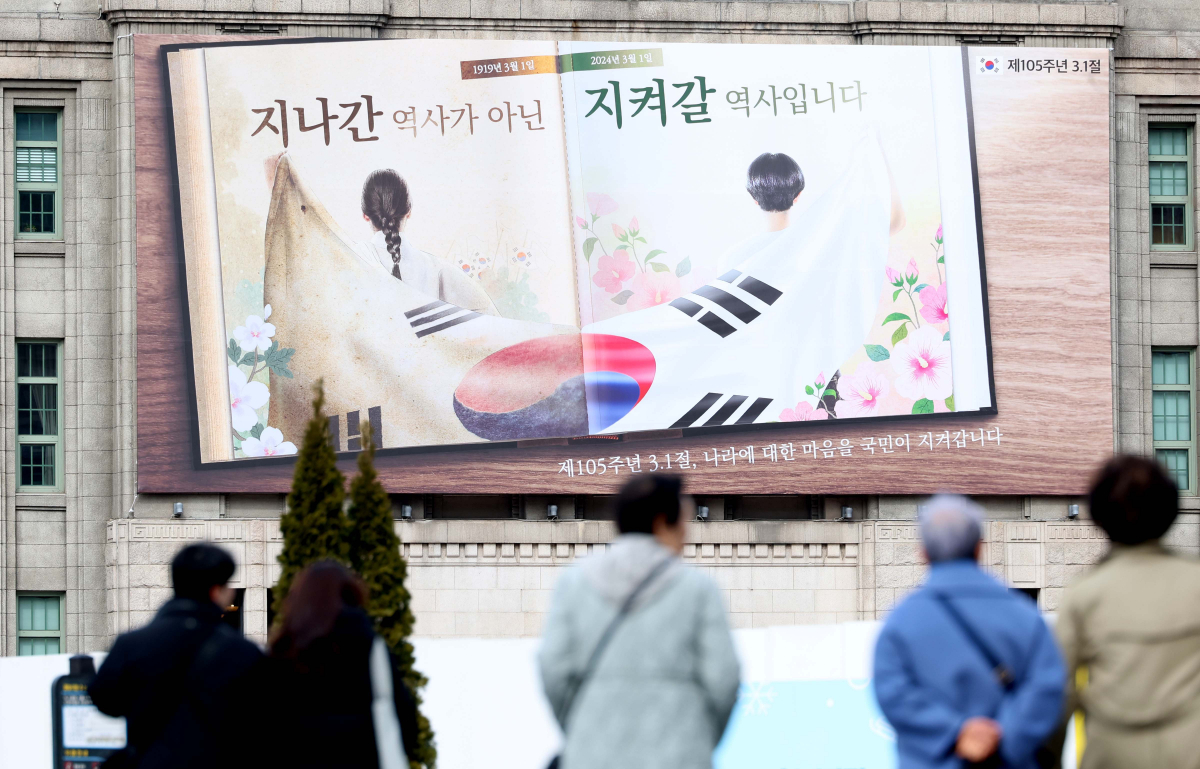 ▲27일 서울 중구 서울도서관 꿈새김판에 제105주년 삼일절을 기념하는 그림과 문구가 게시돼 있다. 꿈새김판에 걸린 주요 이미지는 105년 전 3·1 운동에 참여한 선조와 2024년 대한민국 청년이 함께 태극기를 들고 있는 뒷모습으로 한 권의 책 속에 두 인물을 담아 올해 삼일절도 3·1 운동의 가치를 잇는 역사의 한 페이지가 될 것이라는 메시지를 표현했다고 시 관계자는 설명했다. 이미지 상단에는 “지나간 역사가 아닌 지켜갈 역사입니다”, 하단에는 “제105주년 3·1절, 나라에 대한 마음을 국민이 지켜갑니다”라는 글귀를 배치했다. 신태현 기자 holjjak@