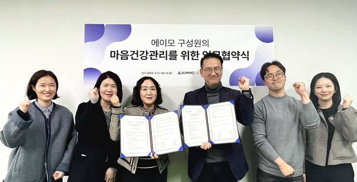 ▲에이모가 지난 12일 성남시정신건강복지센터와 업무 협약을 맺고 직원들을 위한 ‘마음건강관리를 위한 구성원 지원 프로그램’ 지원에 나선다. 협약식에는 에이모 최진오 경영지원부문장(왼쪽에서 4번째), 성남시정신건강복지센터 윤미정 상임팀장(왼쪽에서 3번째) 등 관계자 10여명이 참석했다. (사진제공=에이모)