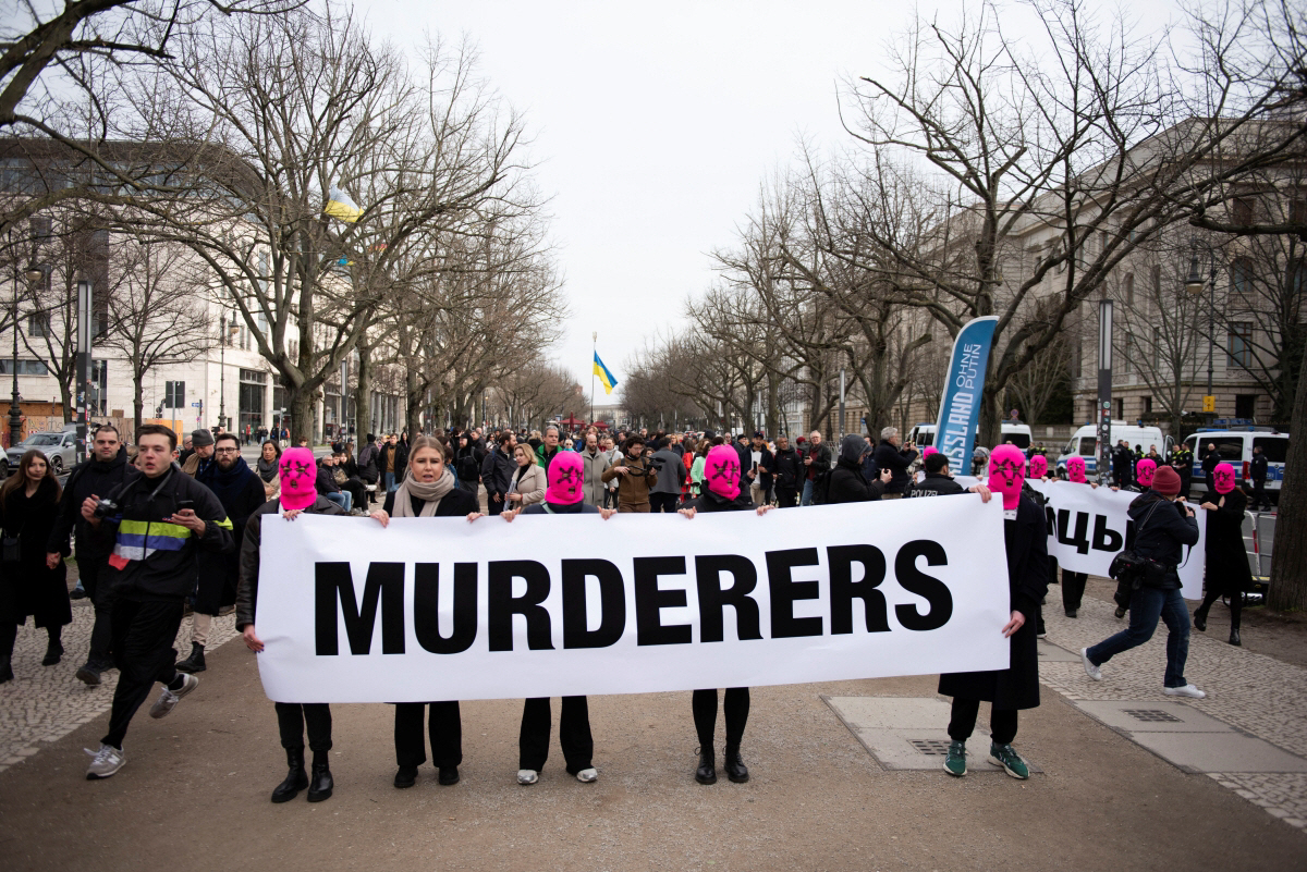 ▲지난달 18일(현지시간) 독일 베를린에 있는 러시아 대사관 앞에서 러시아 반정부 시위단체인 ‘푸시 라이엇’ 회원들이 야권 지도자 알렉세이 나발니(47)의 죽음과 관련해 ‘살인자들’이라고 쓰인 현수막을 들고 있다. 나발니는 지난 16일 수감 중이던 러시아 최북단 시베리아 야말로네네츠 자치구 제3교도소에서 갑작스레 사망했다. 그의 시신에서는 멍 자국과 심폐소생술(CPR)의 흔적이 발견된 것으로 알려졌다. (AP/뉴시스)
