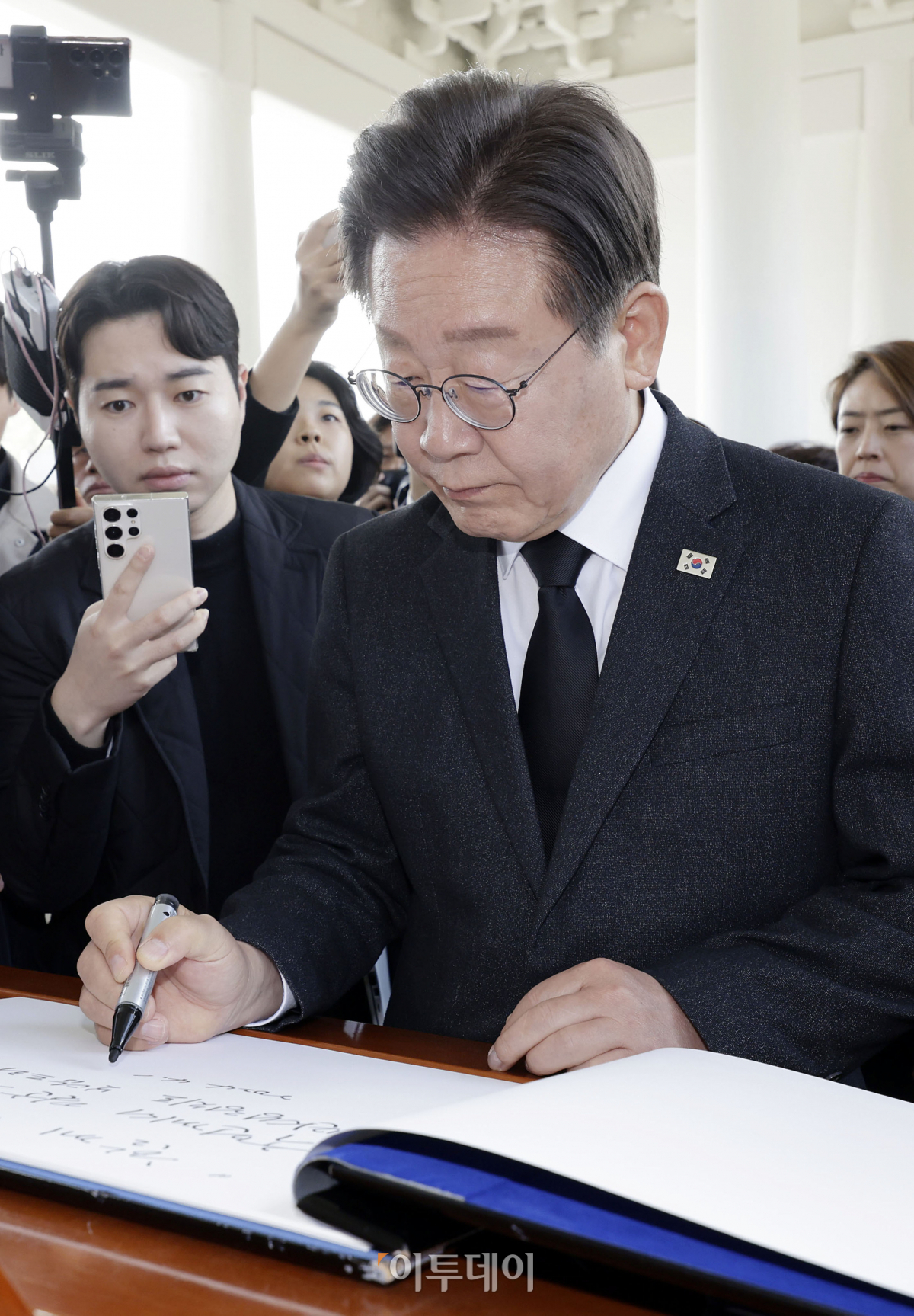 ▲이재명 더불어민주당 대표가 12일 서울 동작구 국립서울현충원에서 지역구 당선인, 더불어민주연합 비례대표 당선인들과 참배한 뒤 방명록 작성을 하고 있다. 조현호 기자 hyunho@