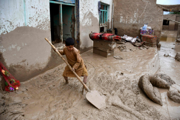 ▲10일(현지시간) 대규모 홍수가 발생한 후 한 아프가니스탄 소년이 집 안뜰에서 진흙을 퍼내고 있다. 바글란(아프가니스탄)/AFP연합뉴스