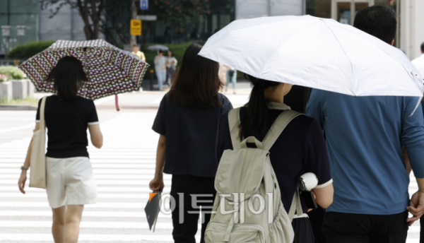 ▲서울 등 수도권에 폭염경보가 내려진 7월 31일 서울 영등포구 여의도역 일대에서 양산을 쓴 시민들이 발걸음을 옮기고 있다. 서울은 열흘째 열대야가 이어진 가운데 이날 한낮 체감온도가 34도로 예상됐다. 다음 주말까지 33도를 웃도는 폭염과 함께 밤사이 열대야가 지속할 것으로 전망된다. 조현호 기자 hyunho@ (이투데이DB)