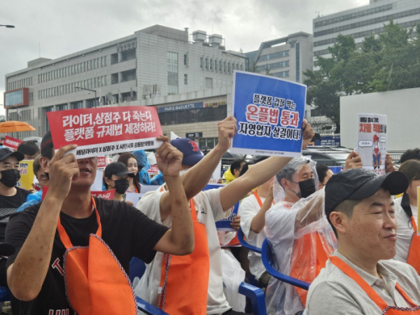 ▲22일 서울 용산구 대통령실 앞에서 열린 ‘배달플랫폼 자율규제 규탄’ 집회 현장에서 참석자들이 피켓을 들고 구호를 외치고 있다. (문현호 기자 m2h@)