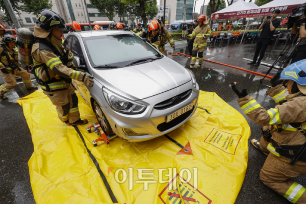 ▲2일 서울 서초구 매헌시민의 숲 동측 공영주차장에서 열린 전기차 화재 대응 합동 소방훈련에서 서초소방서 대원들이 이동식 수조 설치 후 화재 차량을 이동식 수조 위로 이동시키고 있다. 이날 서초구와 서초소방서는 최근 전기차 화재 사건 발생으로 대형 피해가 발생함에 따라 전기차 화재 발생시 피해를 최소화하기 위해 합동 훈련을 실시했다. 조현호 기자 hyunho@