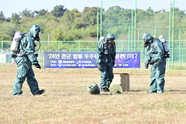 ▲합참이 31일 공군 제20전투비행단에서 우주항공청, 한국천문연구원, 소방청 등 유관기관이 참여한 가운데 관·군 합동 우주위험 대응훈련(FTX)을 실시했다고 밝혔다. 공군 제20전투비행단 관계관들이 지면 충돌 현장에서 방사능 탐지, 폐기물 수거 등을 조치하고 있다. (연합뉴스)