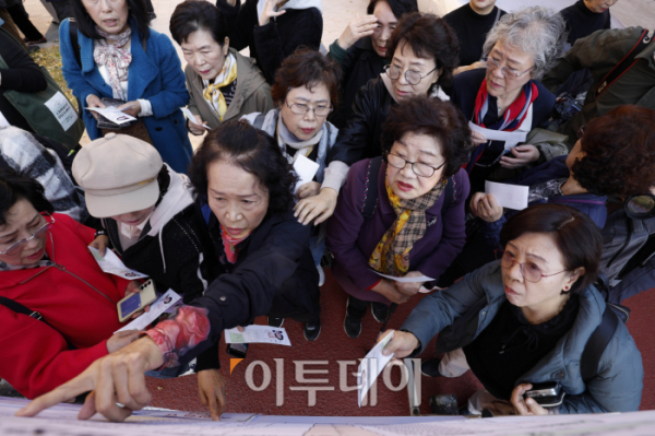 ▲일성여자중고등학교 수능 최고령 응시자 임태수(83·앞줄 오른쪽 두 번째) 씨 등 수험생들이 13일 서울 마포구 홍익대학교 사범대학 부속 여자고등학교에서 고사장 확인을 하고 있다. (조현호 기자 hyunho@)