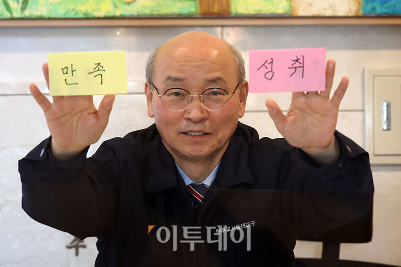 ▲유형진 서울대교구청 안내원이 서울 중구 명동성당에서 2024년은 ‘만족’, 2025년은 ‘성취’ 키워드를 소개하고 있다. 고이란 기자 photoeran@