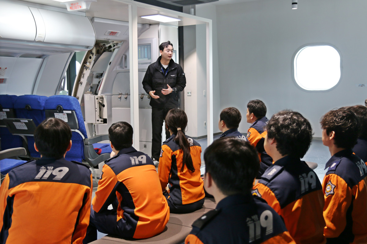 ▲9일 에어부산 사옥 훈련시설에서 부산소방재난본부 소방관들이 비상구 조작법을 배우고 있다. (사진=에어부산)