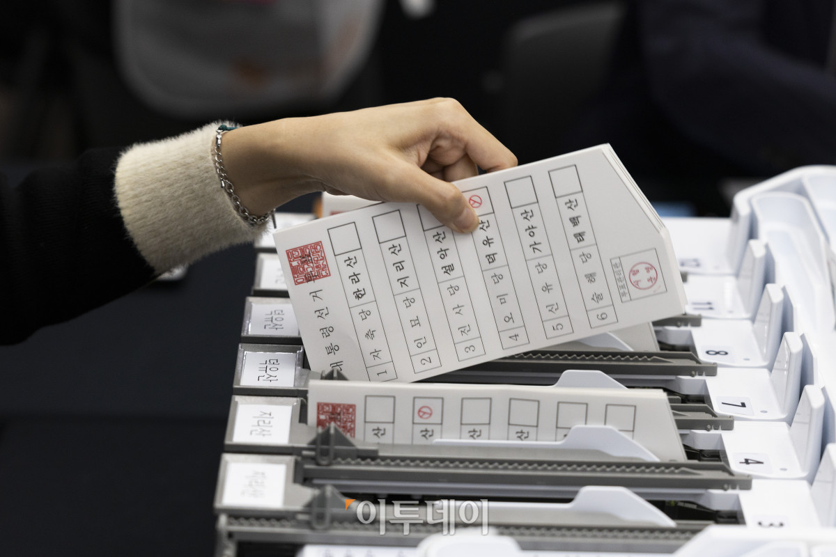 ▲10일 오후 경기도 과천시 중앙선거관리위원회에서 열린 제21대 대통령 선거 투·개표 절차 시연회에서 투표지 분리기를 통과한 투표지를 꺼내고 있다. 조현호 기자 hyunho@