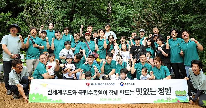 ▲신세계푸드 임직원과 가족들이 21일 경기 포천시 국립수목원 내 정원 조성 활동 후 기념사진을 찍고 있다. (사진제공=신세계푸드)