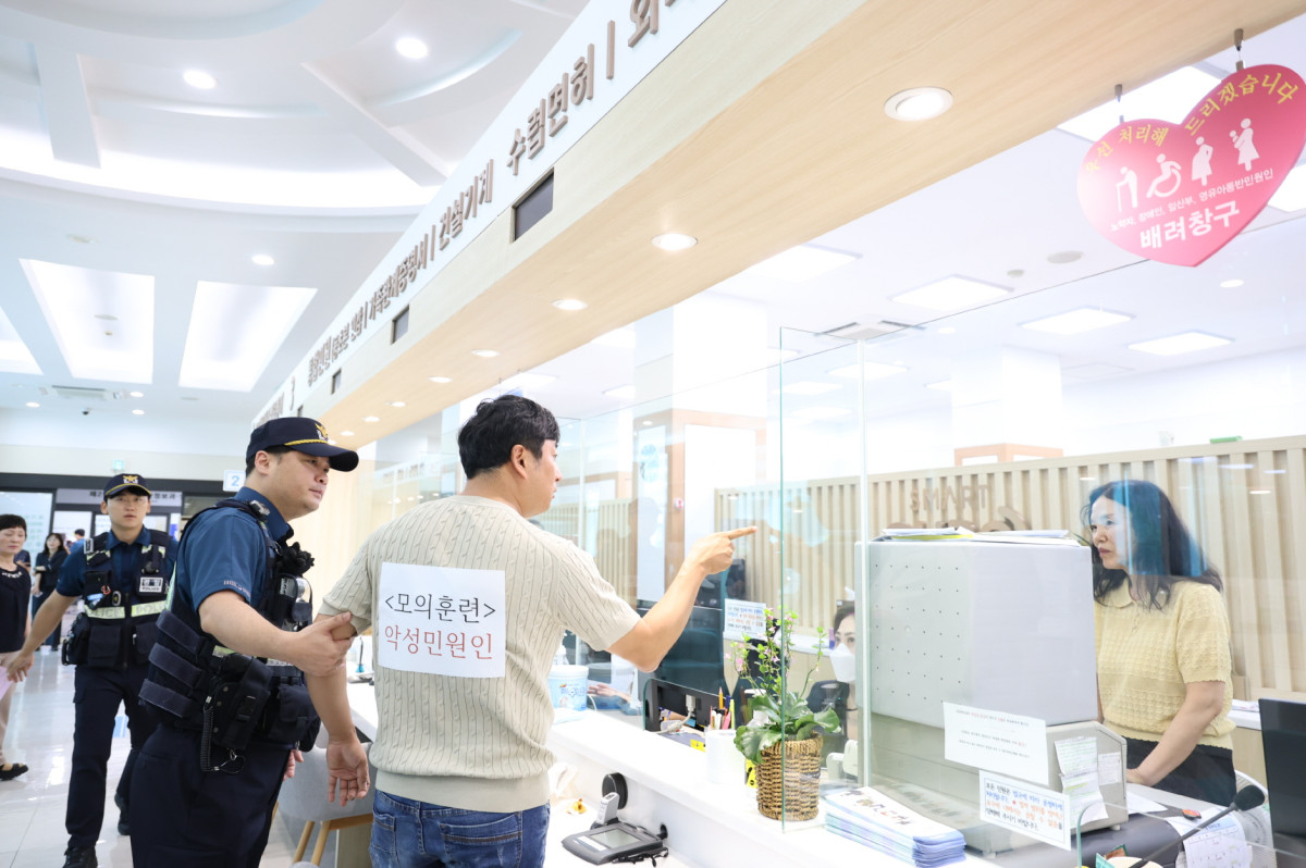 ▲모의훈련 상황에서 민원인이 경찰 앞에서 구청 직원들에게 폭언을 하고 있다. (사진제공=구로구)