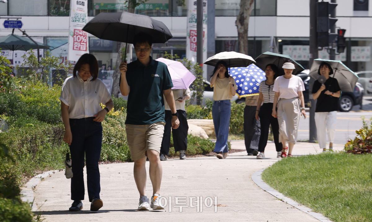▲서울 낮 최고기온이 37도를 기록하는 등 전국 대부분 지역에 폭염이 기승을 부린 29일 서울 송파구 석촌호수 인근에서 양산을 쓴 시민들이 더위를 피해 발걸음을 옮기고 있다. 조현호 기자 hyunho@
