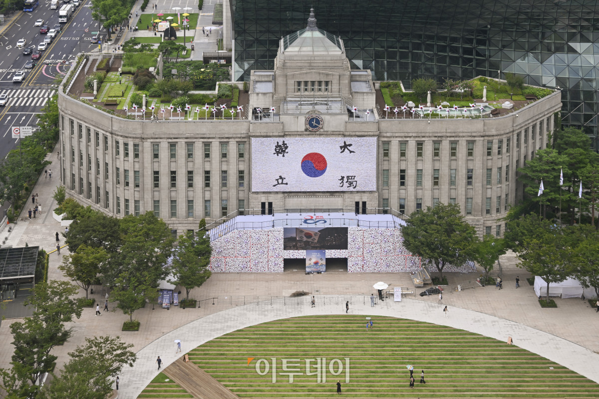 ▲제80주년 8·15 광복절을 앞둔 8일 서울 중구 서울도서관 정문 앞에 태극기 언덕이 설치되고 있다. 가로 45m·폭 5m·높이 6m 규모의 태극기 언덕은 우리 민족이 광복을 염원하며 흔들었던 태극기를 형상화한 세 가지 크기, 300개의 바람개비로 꾸며 광복의 자부심과 기쁨을 형상화한 작품이다. 시민들은 언덕에 직접 올라 꿈새김판에 걸려 있는 안중근 열사의 '단지동맹 혈서 태극기' 가까이에서 기념사진을 찍고, 서울광장에 펼쳐지는 다양한 전시와 행사도 조망할 수 있다. 조현호 기자 hyunho@