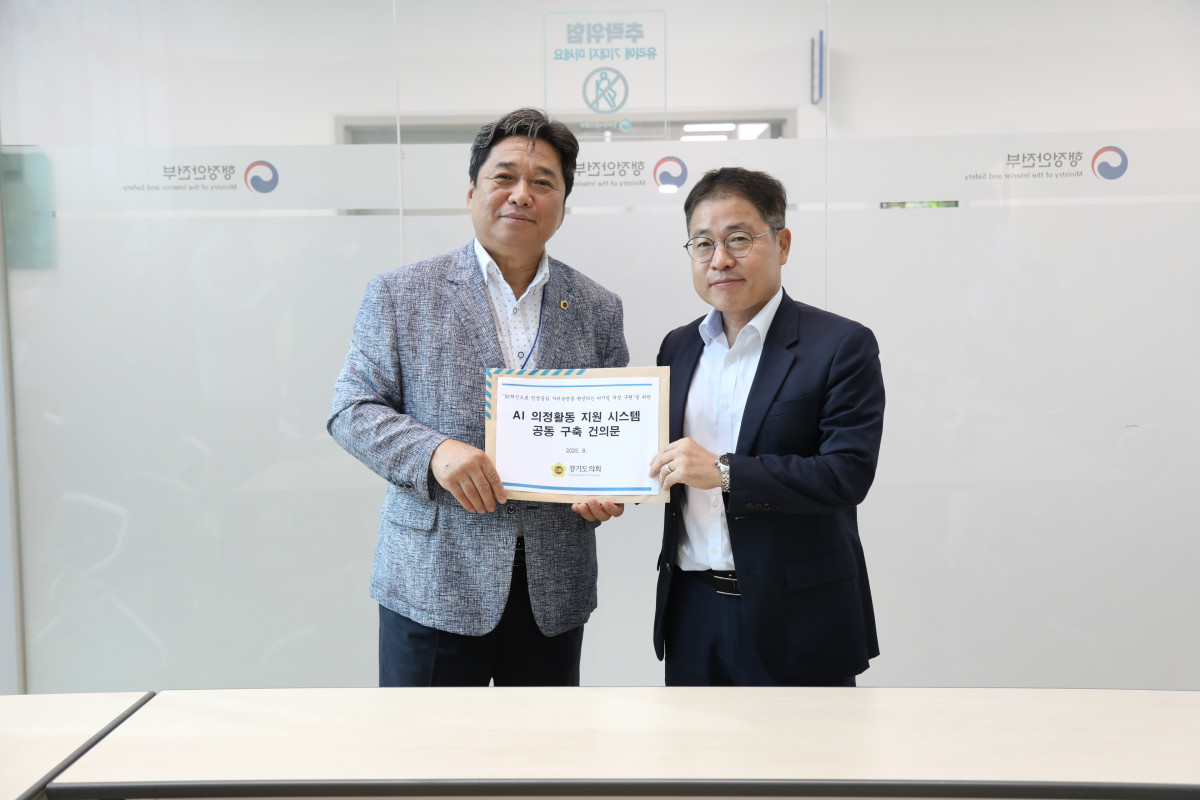 ▲김호겸 경기도의회 정보화위원장(왼쪽)이 행정안전부 관계자에게 ‘AI 의정활동 지원 시스템 공동 구축 건의문’을 전달하고 있다. (경기도의회)