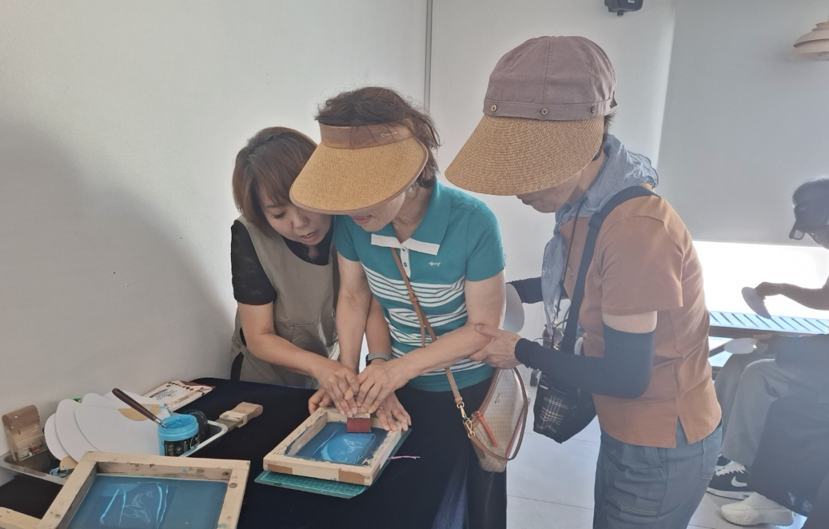 ▲시각장애인이 야광 실크스크린 부채만들기를 하고 있다.  (사진제공=시각장애인협회)