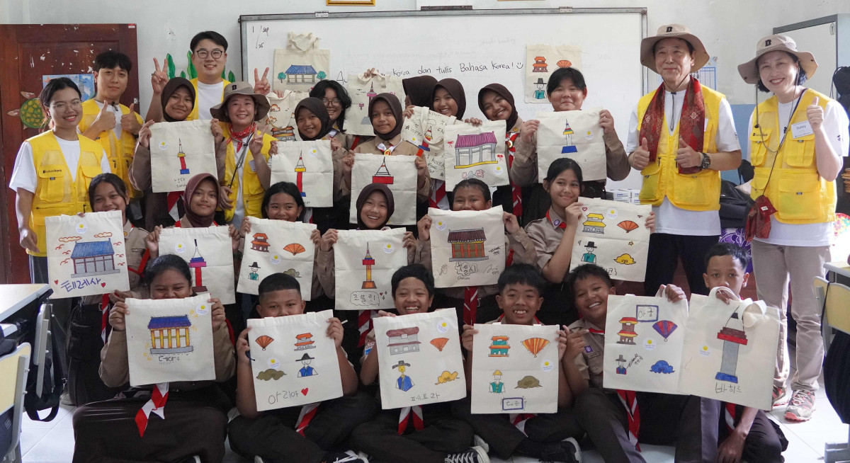 ▲카카오뱅크 임직원들이 인도네시아 라젝 지역에서 현지 학생들을 만나 문화교류 활동을 진행한 뒤 기념촬영을 하고 있다. (사진제공=카카오뱅크)