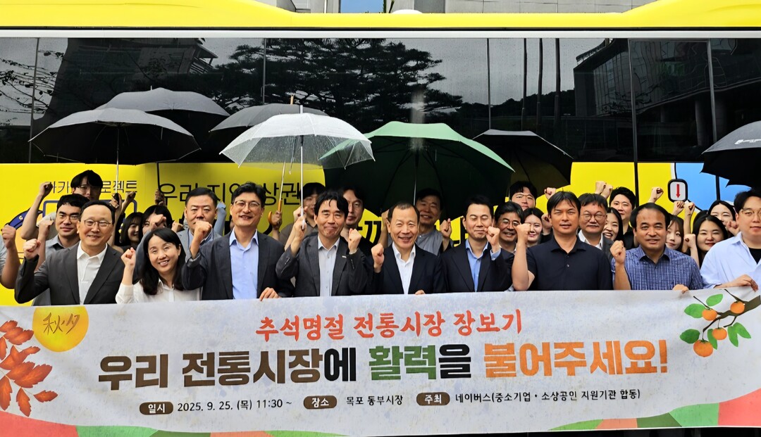 ▲추석 명절을 앞둔 목포 동부시장 인근에서 우산을 쓴 참석자들이 전통시장 활성화를 알리는 현수막을 들고 지역경제 회복을 위한 행사를 진행하고 있다. (사진제공=전남도)