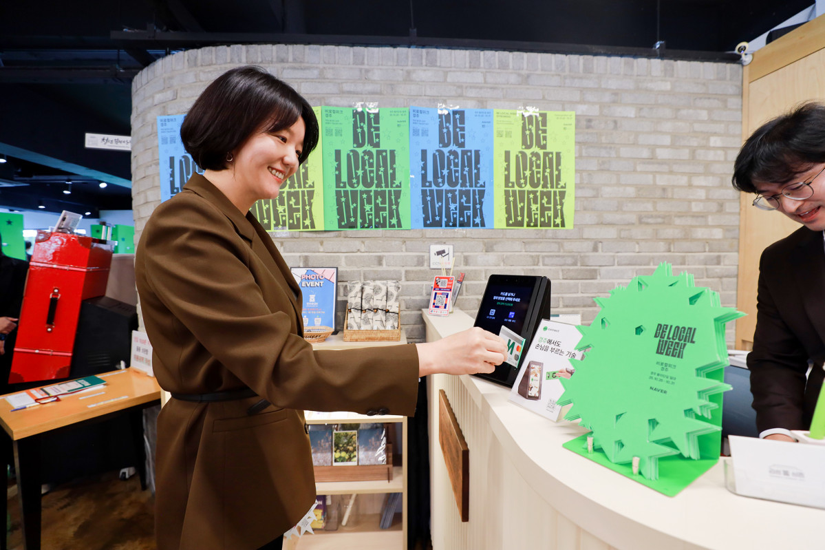 ▲캠페인 현장에서 네이버페이 오프라인 통합 단말기 ‘Npay 커넥트’로 결제를 진행 중인 최수연 대표 (사진제공=네이버)