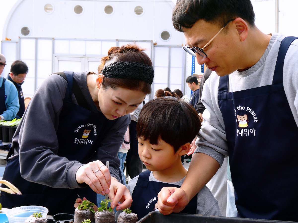 ▲현대위아 임직원과 가족들이 지난 1일 경기도 이천시 포레스트벤처스 식물연구센터에서 오동나무 묘목을 분갈이하는 모습. (사진=현대위아)