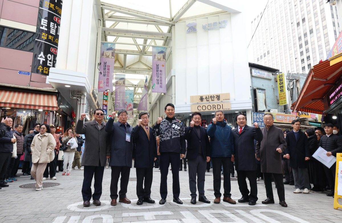 ▲17일 서울 중구 남대문시장 일대에서 열린 ‘남대문시장 아케이드 조성 준공식’에서 오세훈 서울시장과 김길성 중구청장 등이 기념촬영을 하고 있다. 남대문시장 중심가로 약 135m 구간에 조성된 아케이드는 한옥 처마를 형상화했다. 신태현 기자 holjjak@