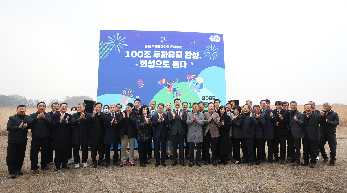 ▲화성 국제테마파크 조성 현장에서 ‘100조 투자유치 완성, 화성으로 쏟다’ 팻말 앞에 모여 기념 촬영을 하고 있다. (경기도)