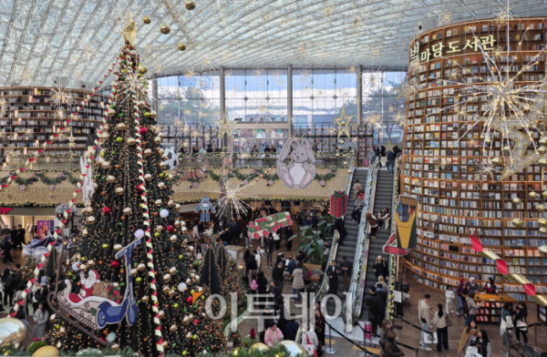 ▲20일 서울 삼성동 스타필드 코엑스몰 별마당 도서관에서 방문객들이 연말 분위기를 즐기고 있다. '책 속에서 펼쳐지는 크리스마스 축제' 를 주제로 마련된 이번 캠페인은 종이로 구현된 세 개의 챕터를 따라 도서관 전체가 한 권의 팝업북처럼 펼쳐진다. 방문객들은 페이지를 넘기듯 크리스마스 동화 속 세계를 체험할 수 있다. 고이란 기자 photoeran@ (이투데이DB)