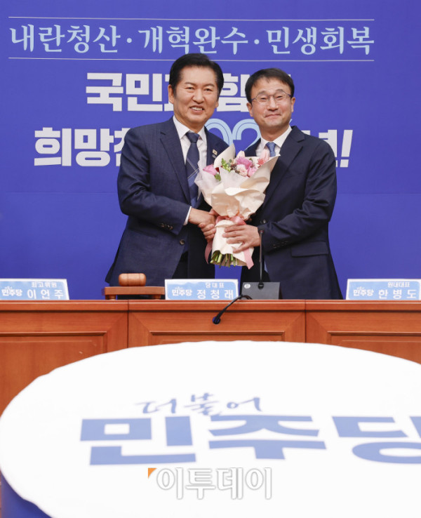 ▲더불어민주당 한병도(오른쪽) 신임 원내대표가 12일 서울 여의도 국회에서 열린 더불어민주당 최고위원회의에서 정청래 대표에게 꽃다발을 전달받은 후 기념촬영을 하고 있다. 조현호 기자 hyunho@