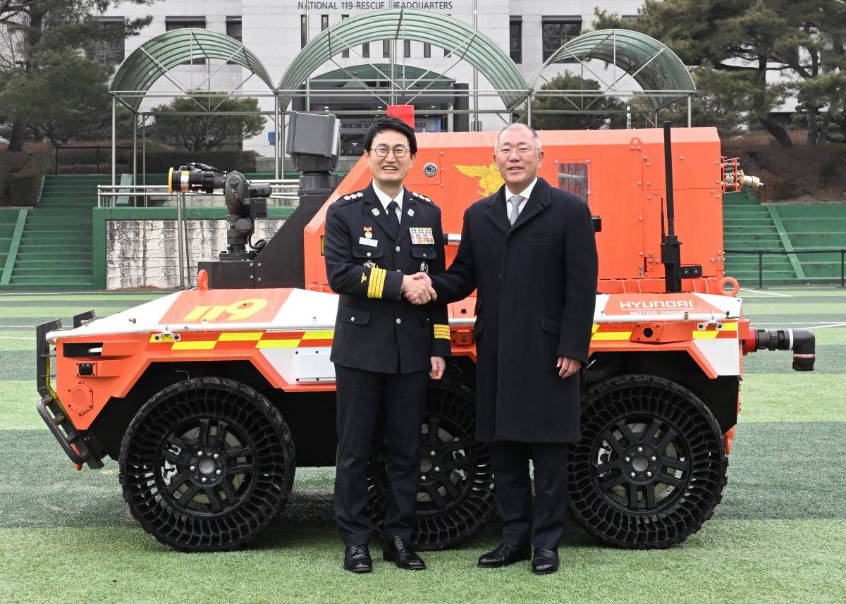 ▲(왼쪽부터) 소방청 김승룡 소방청장 직무대행과 현대차그룹 정의선 회장이 무인소방로봇과 함께 기념 촬영을 하고 있는 모습. (사진=현대차그룹)
