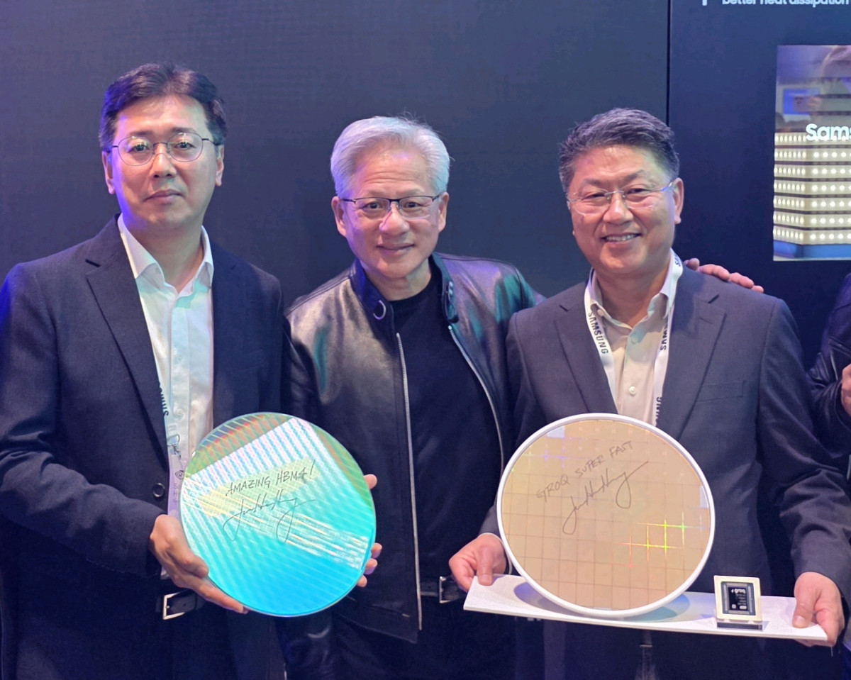 ▲엔비디아 젠슨 황 CEO가 GTC 2026 현장에서 삼성전자 부스를 방문해 기념촬영을 하고 있는 모습.  사진 좌측부터 황상준 메모리개발담당 부사장, 엔비디아 젠슨 황 CEO,  한진만 파운드리 사업부장 사장. 제품은 사진 좌측부터 삼성전자 HBM4 코어다이 웨이퍼와 그록(Groq) LPU 파운드리 4나노 웨이퍼. 각 웨이퍼에는 'AMAZING HBM4'와 'Groq Super FAST'라는 젠슨 황 CEO의 친필 서명이 적혀있다. (사진제공-삼성전자)